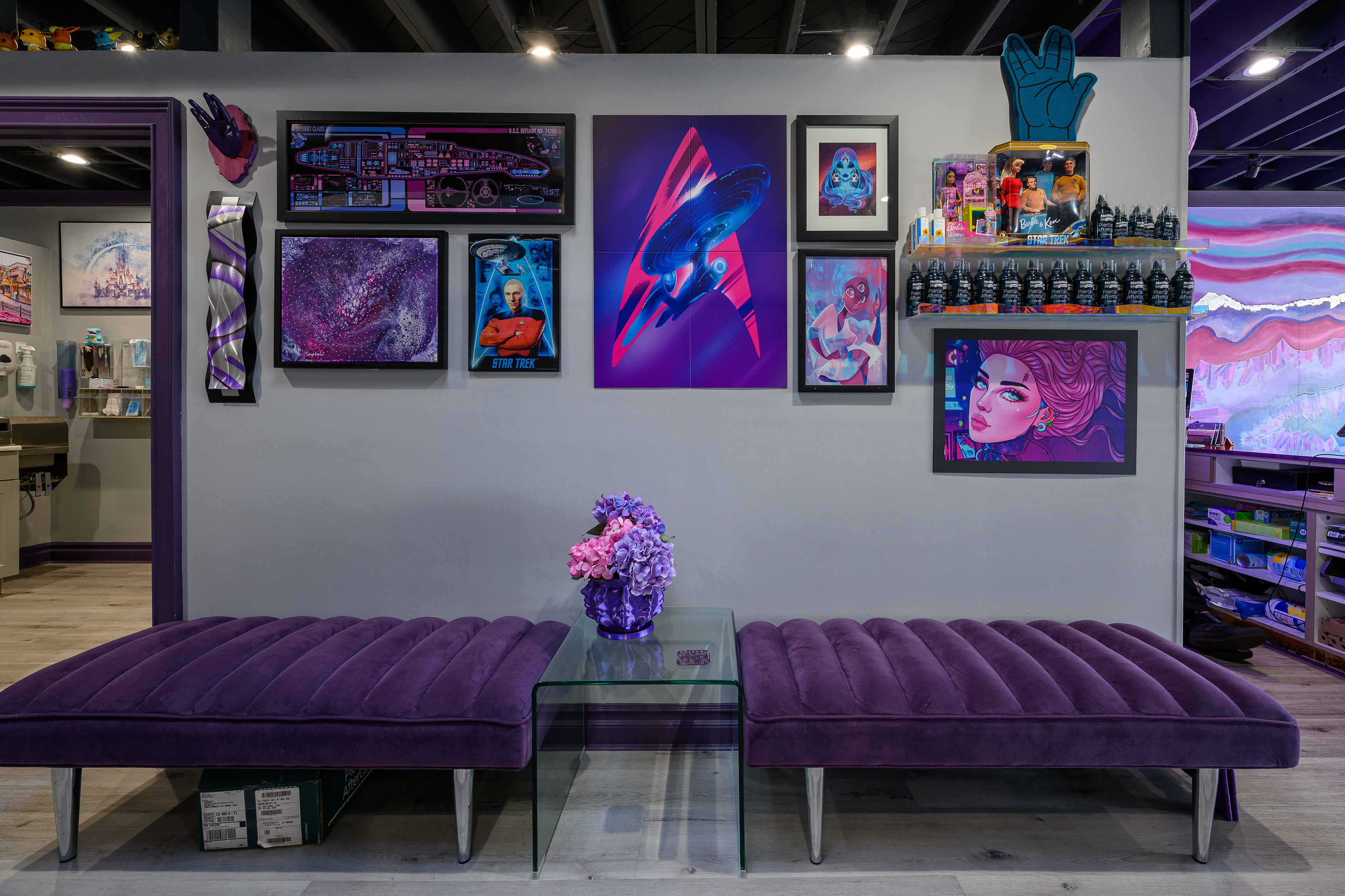 Studio waiting area with purple benches and a wall of colorful artwork