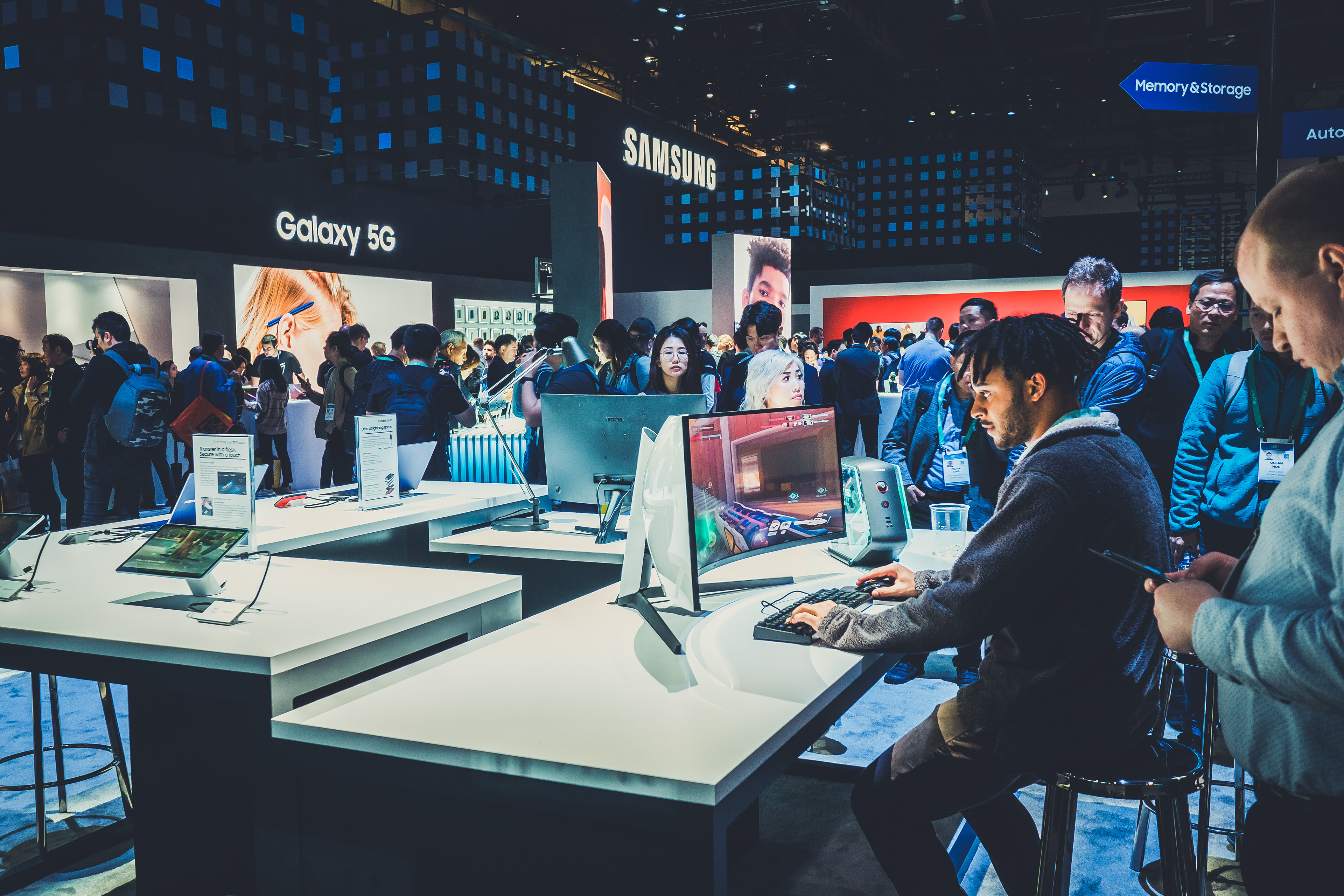 Attendees trying computers at the Samsung exhibition booth, CES 2020.