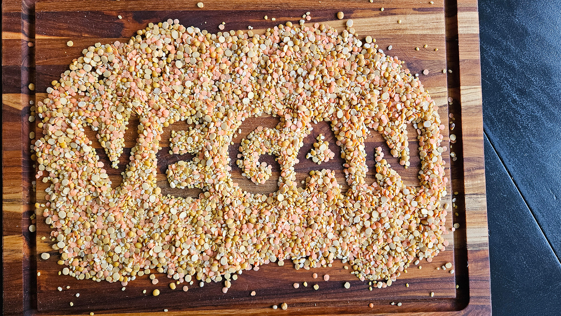 Original photo taken in my kitchen with lentils on a cutting board ad letters drawn out with my finger.