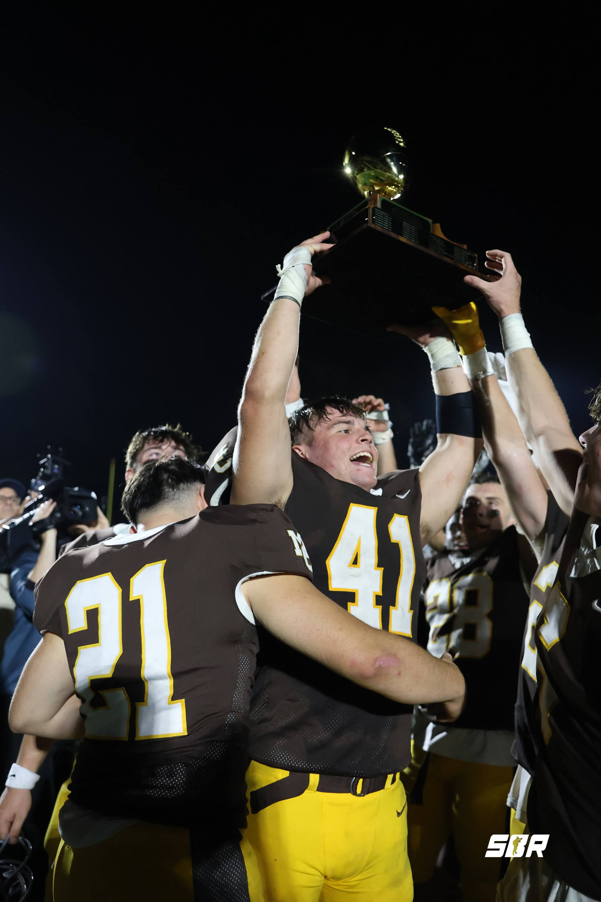 Matt Mucha (41) Lifts the Carmelite Classic Trophy after a big win versus the Joliet Catholic Academy Hilltoppers