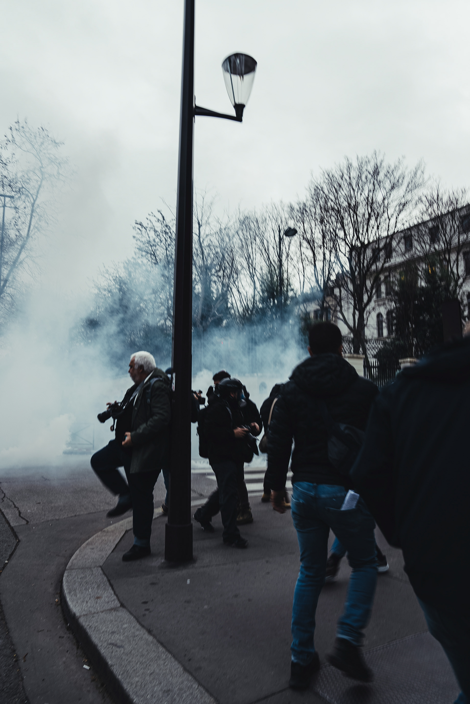 Crowd running from tear gas