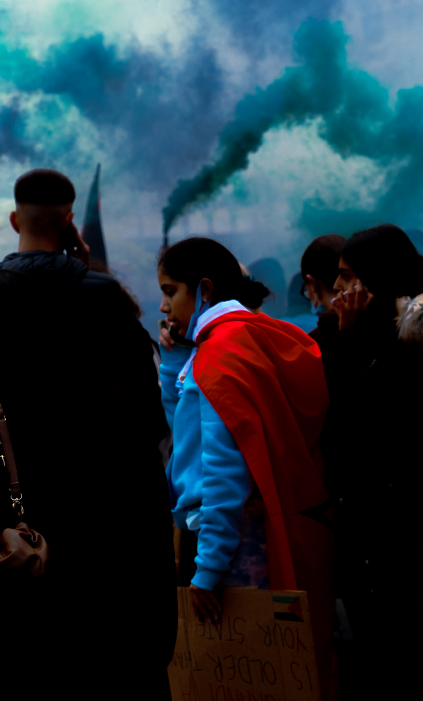 A woman wearing a cape in solidarity with Palestine