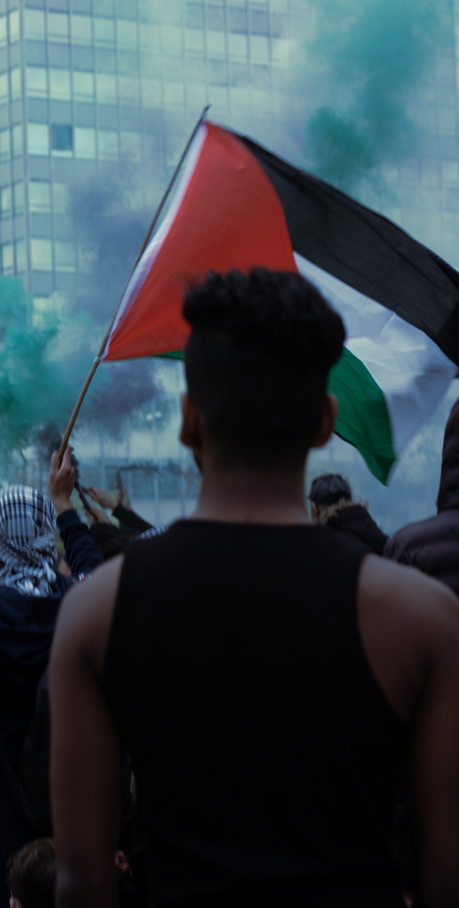 A man in the protest looks ahead at some protestors being arrested in the centre of the square