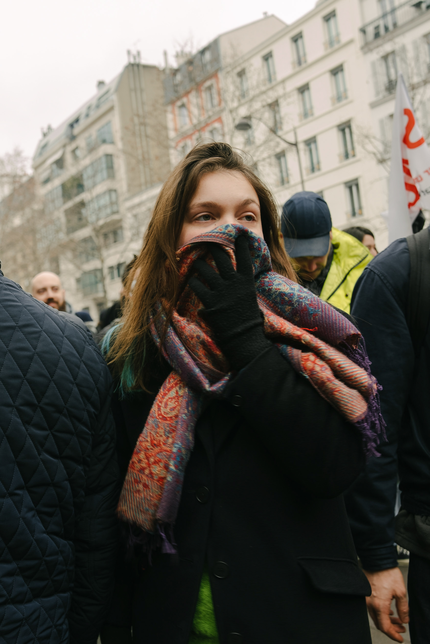 A person covers their face from the tear gas