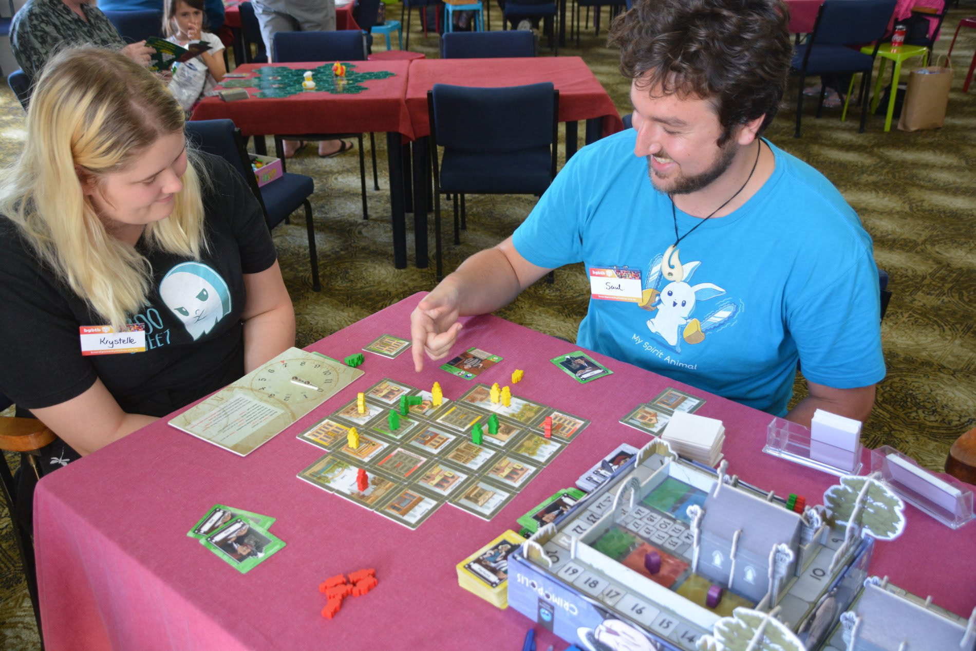 A couple is enjoying the 2-player version of Crimopolis.