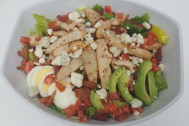 Cobb Salad Chicken breast, avocado, blue cheese, bacon, tomato, egg, lettuce, and Italian dressing.