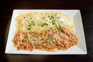 Red & White Spaghetti This half, and half dish with bolognese sauce on one half. Feta, and myzithra cheese on the other.