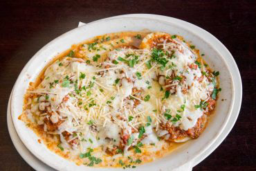 Baked Ravioli Meat stuffed pasta covered with bolognese sauce, mozzarella, and parmesan.
