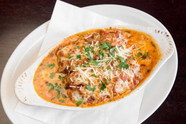 Baked Lasagna Pasta layered with house-made bolognese sauce, ricotta, provolone, romano, parmesan, and mozzarella cheese.