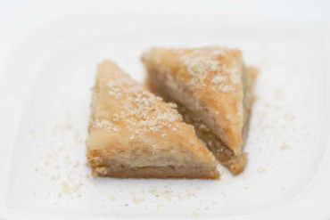 aklava Layers of flaky pastry sheets lightly brushed with butter and capped by a thick sweet syrup-and-nut spread are what make this native dish of Middle East so popular around the world.