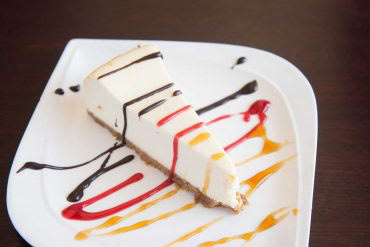 NY Cheesecake Plain or with raspberry, chocolate, or caramel sauce.