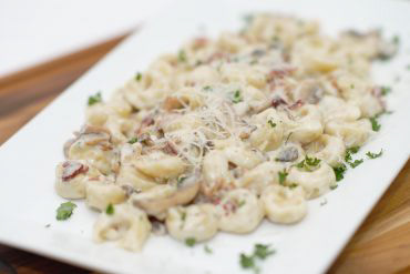 Soprano's Special Pasta Cheese filled tortellini, bacon, mushrooms, home-made Alfredo sauce, and parmesan.
