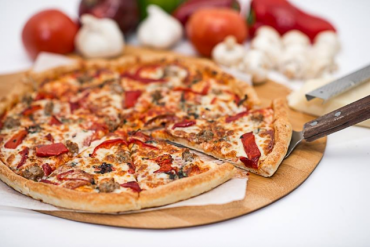 The Mafia Pizza Fire roasted red peppers, Italian sausage, fresh basil, salami, garlic, mozzarella cheese, and pizza sauce.