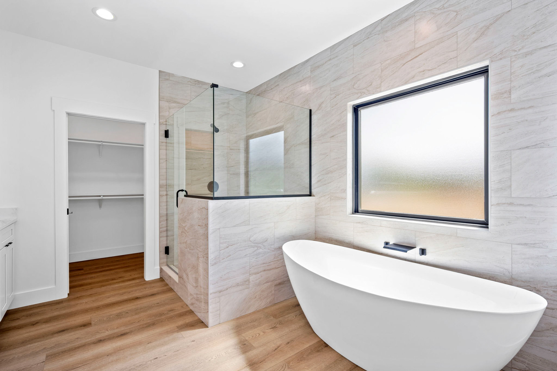 Master Bathroom Featuring Free Standing Tub and Tile Shower