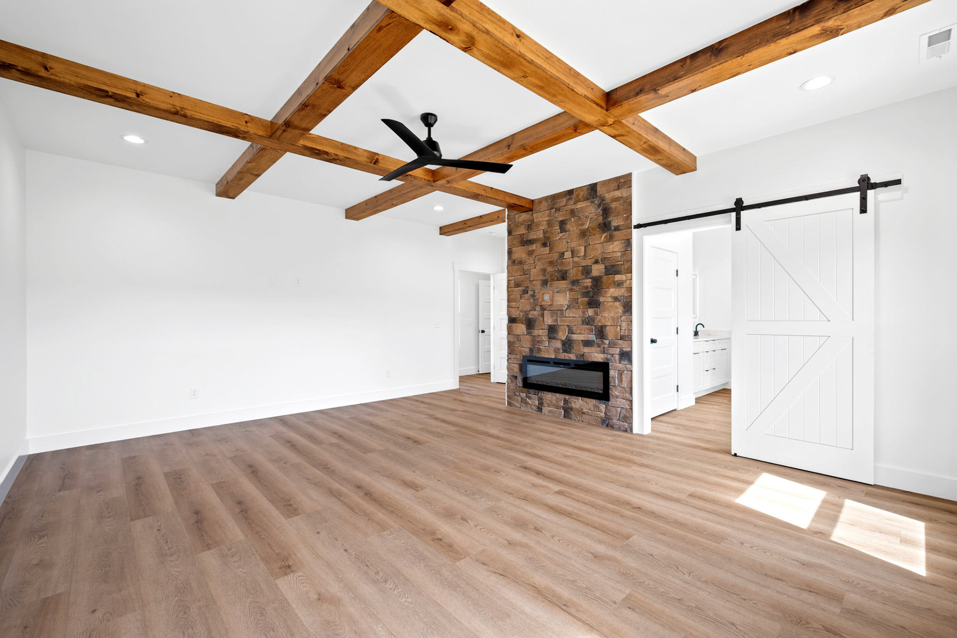 Master Bedroom Featuring Coffered Ceilings & Electric Fireplace
