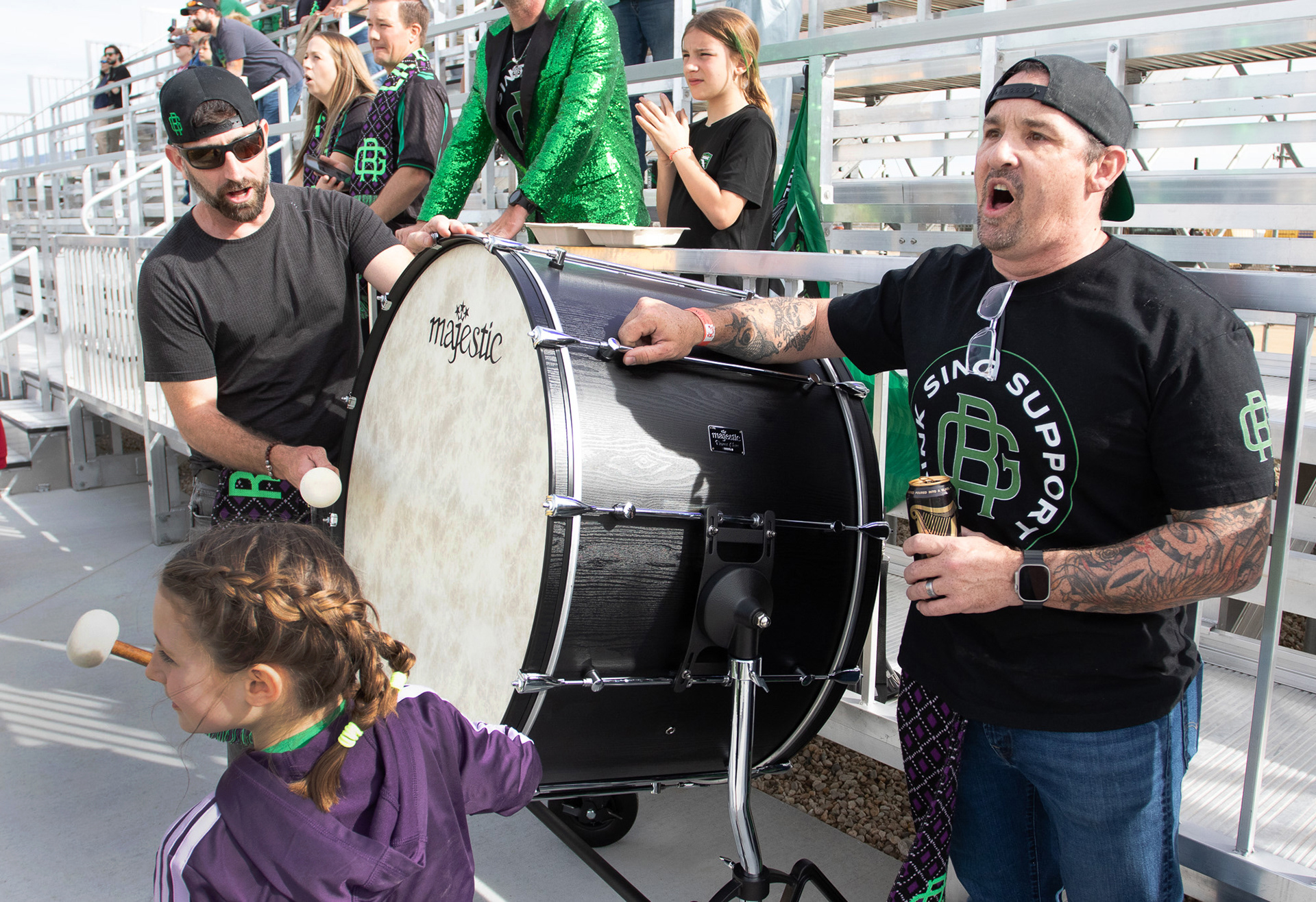 members of the River Guard banging on drum and cheering