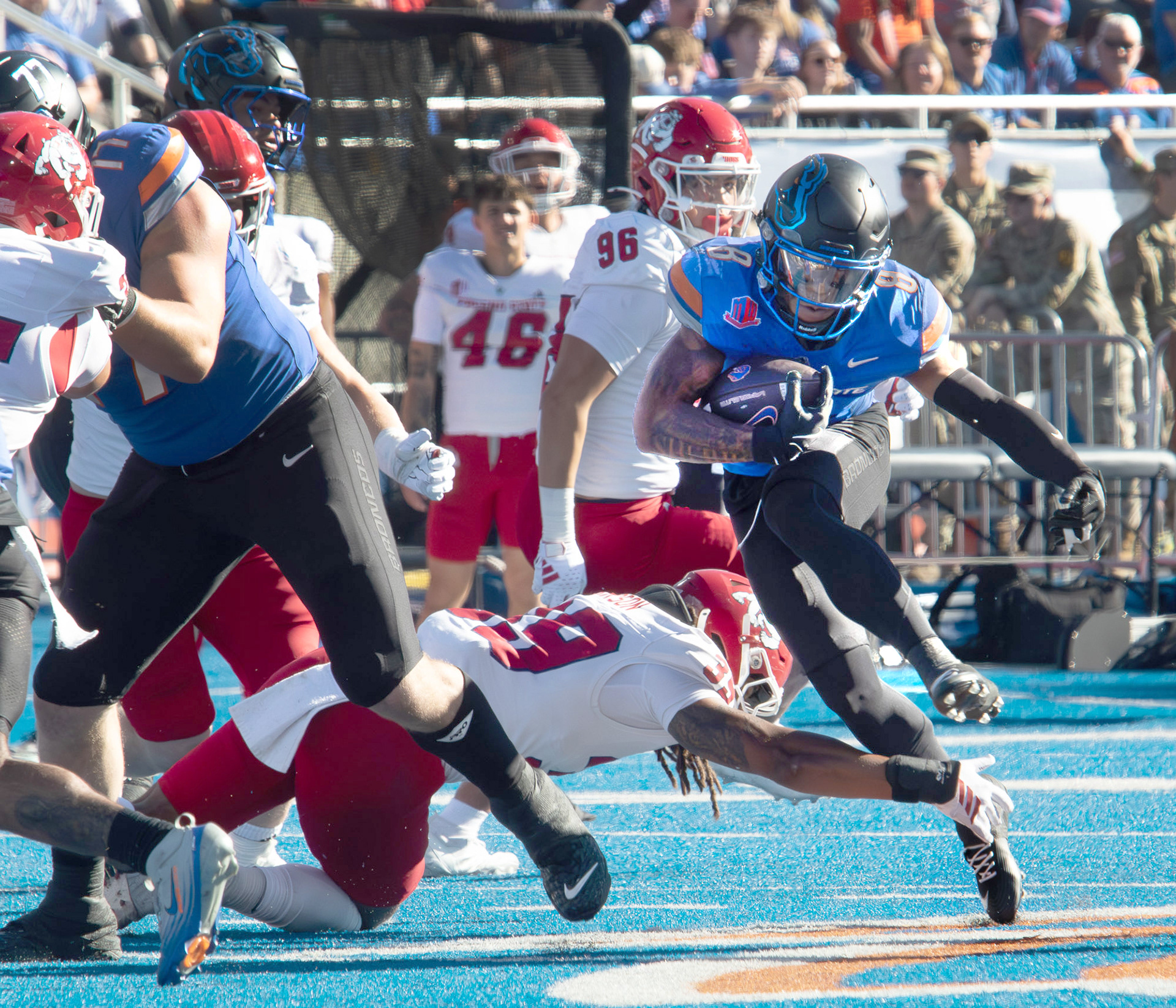 Boise State University's Malik Sherrod jumps over defense with the ball during football game against Fresno State  at Albertsons Stadium Saturday, November 1, 2025