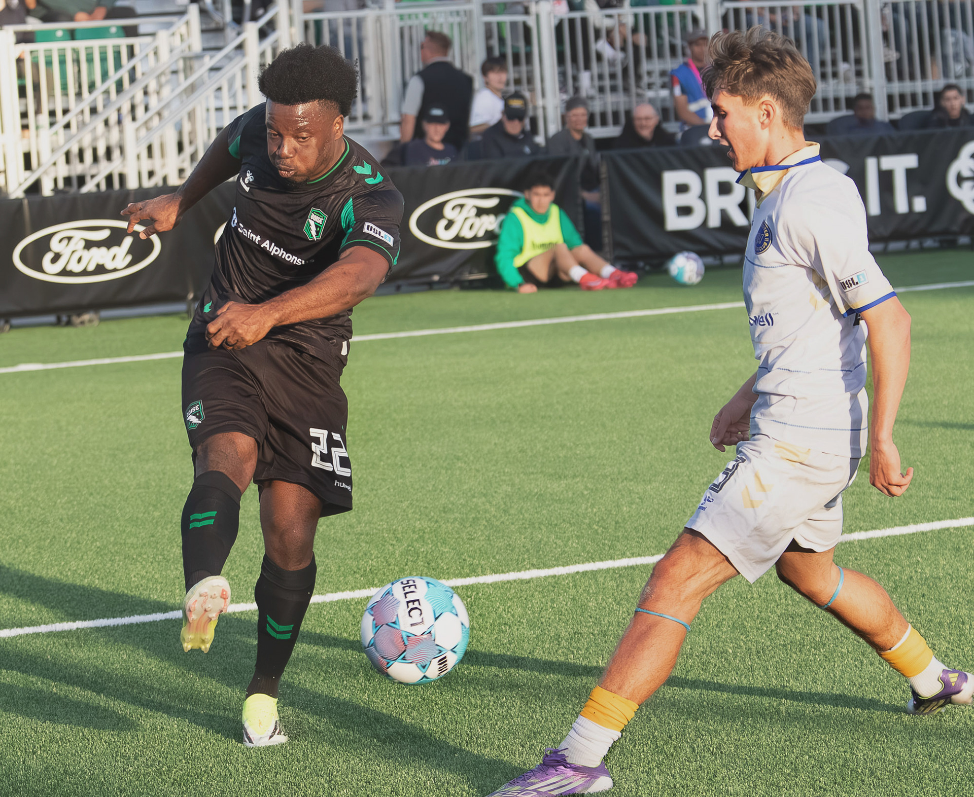 Thomas Amang (22) for Athletic Club Boise takes a shot with Kyle Evans (83) of Westchester Soccer Club defending during soccer match at Les Bois Park on Saturday.