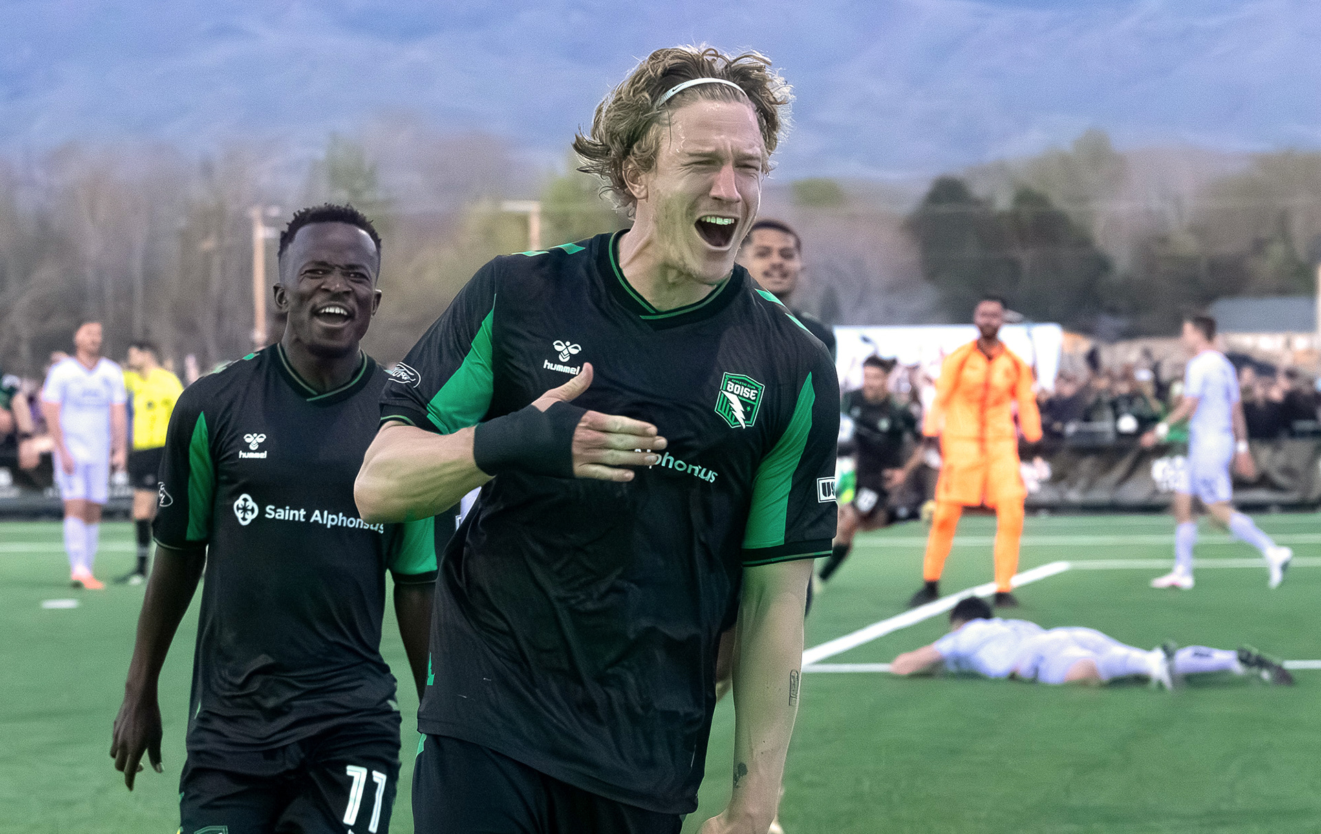 Nick Moon (14) celebrates a goal with Tumi Moshobane #11 during AC Boise's first home game played against Spokane Velocity on Saturday 4.4.26