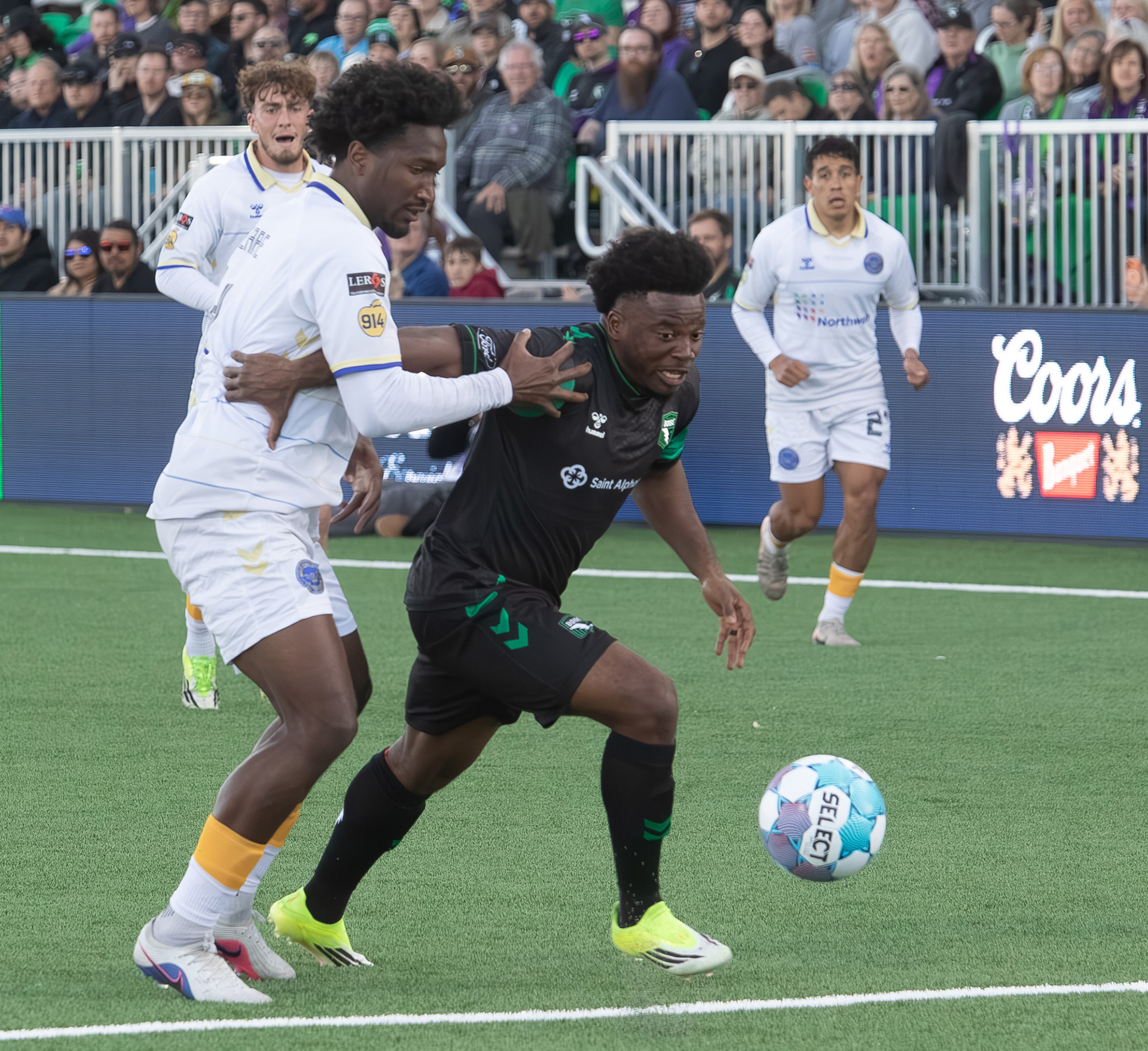 Athletic Club Boise's Thomas Amang (22) tries to maneuver the ball away from Bobby Pierre (4) of  Westchester Soccer Club during soccer match at Les Bois Park on Saturday, April 18, 2026.