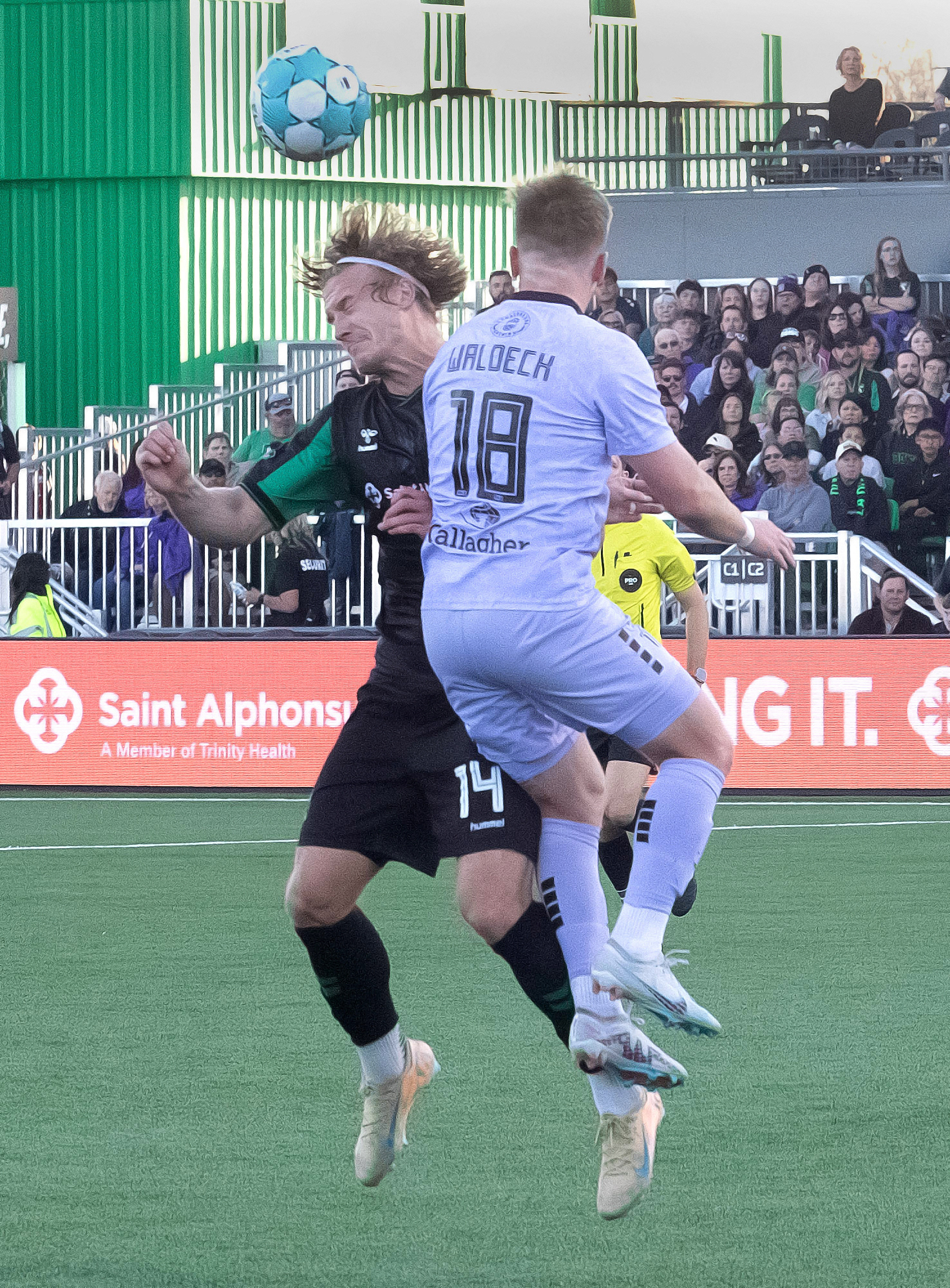 AC Boise's Nick Moon #14 head butts the ball as Spokane Velocity's Derek Waldeck #18 defends