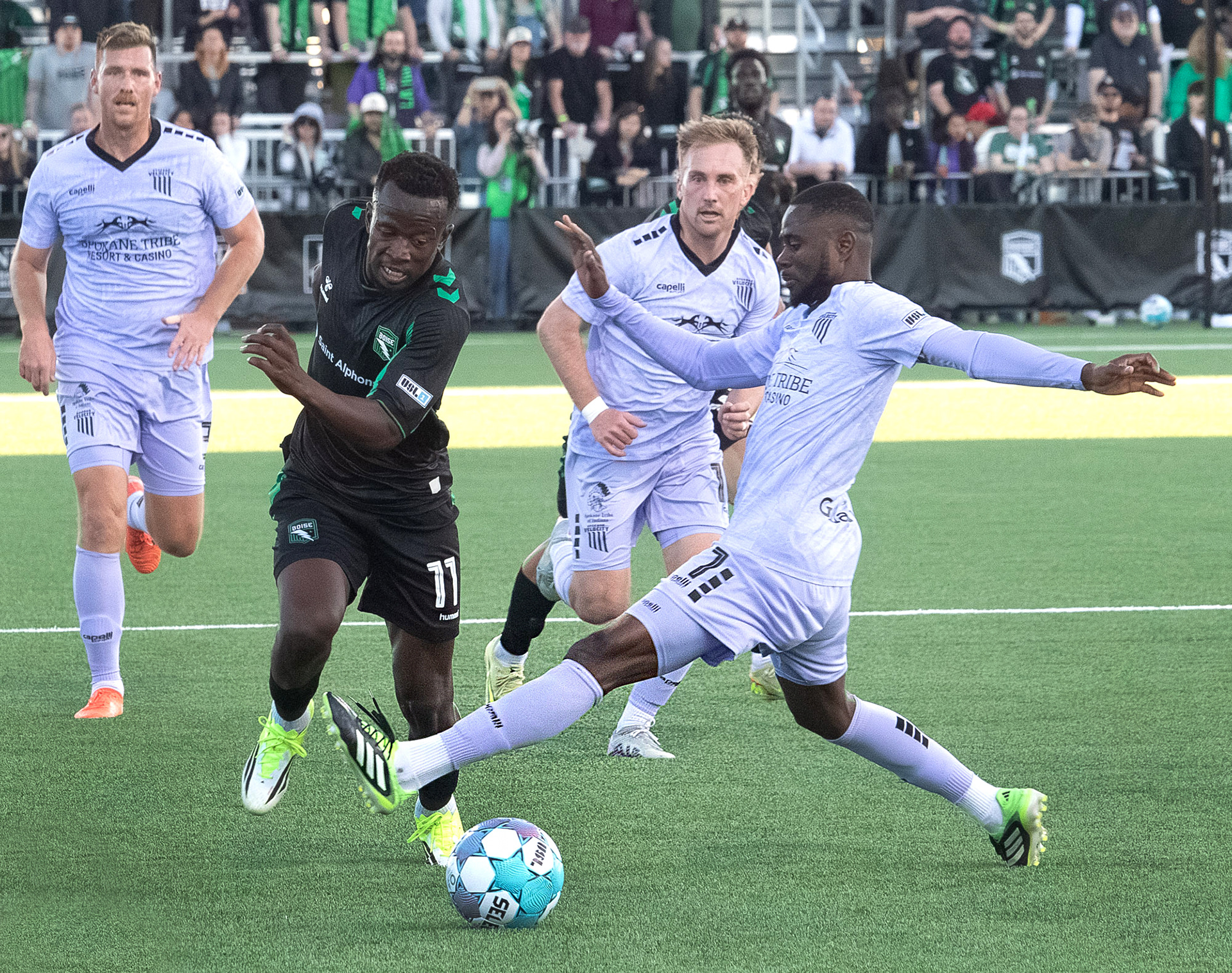 AC Boise's Tumi Moshobane #11 is tripped up by Spokane Velocity's Andre Lewis #77 during first home game for AC Boise played at Les Bois Park on Saturday 4.4.26
