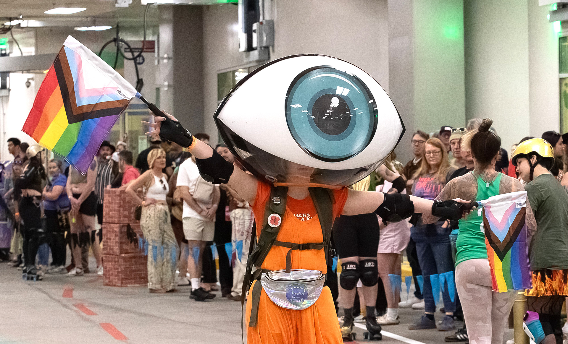 Member of the Eyeball Crew holding race starter flags at the Roller Derby Disco on Sunday