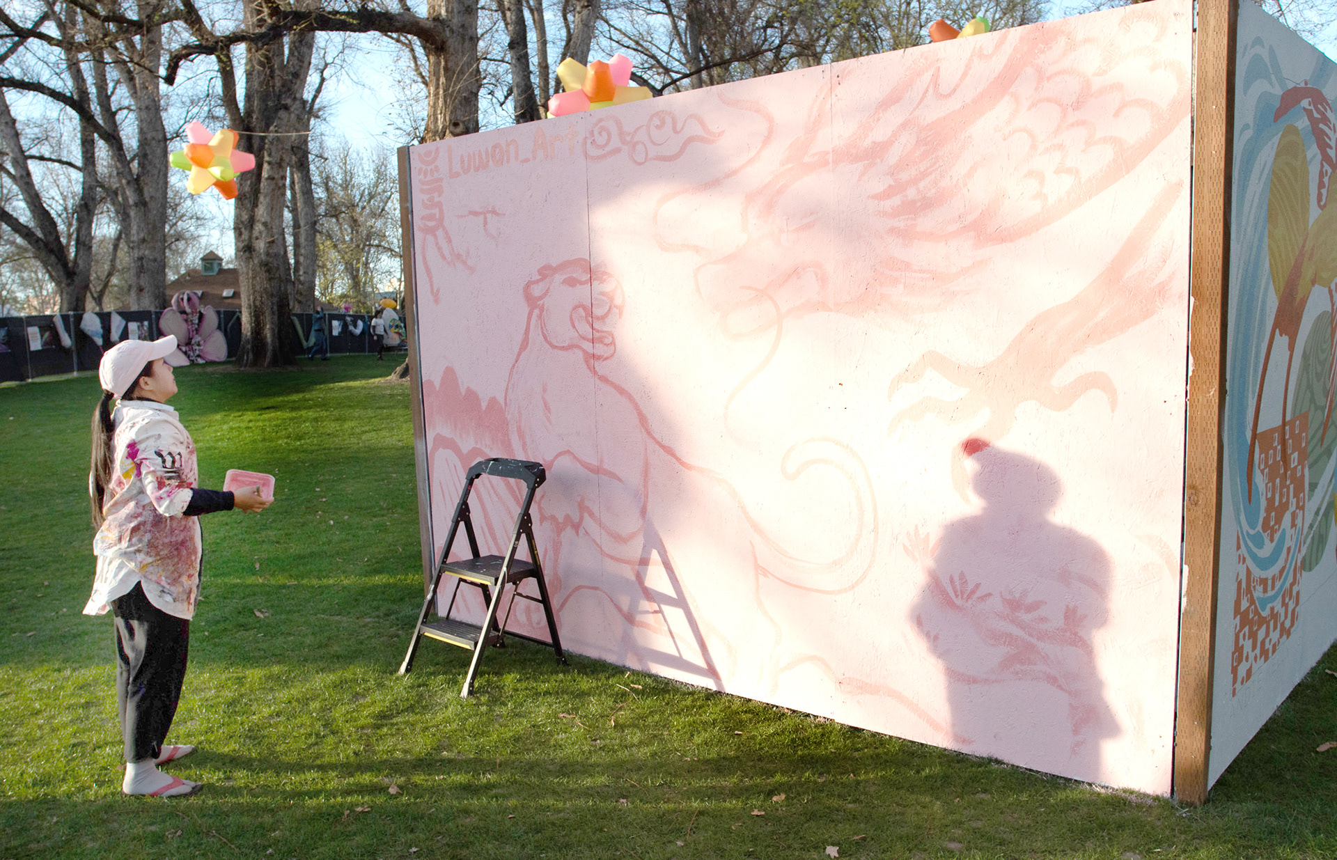 Graffiti artist Luwon steps back to look at her work