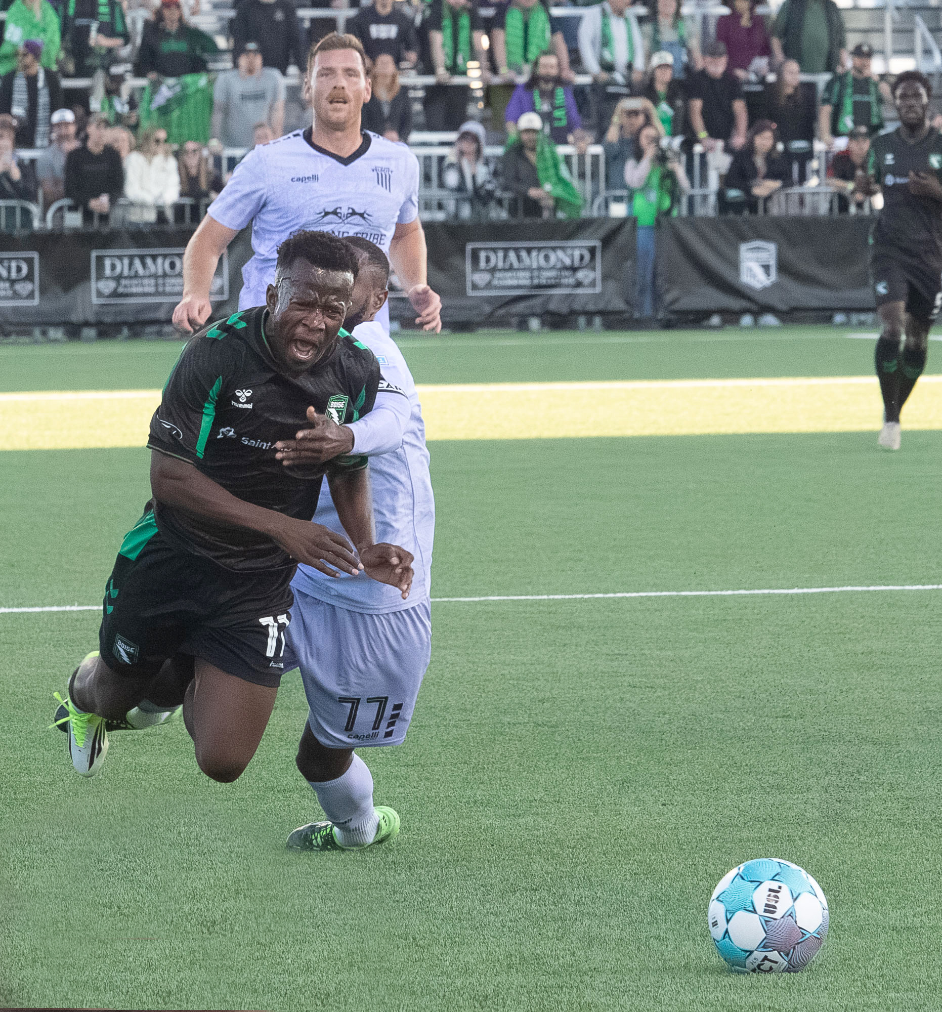 AC Boise's Tumi Moshobane #11 gets tripped up by Spokane Velocity's Andre Lewis #77