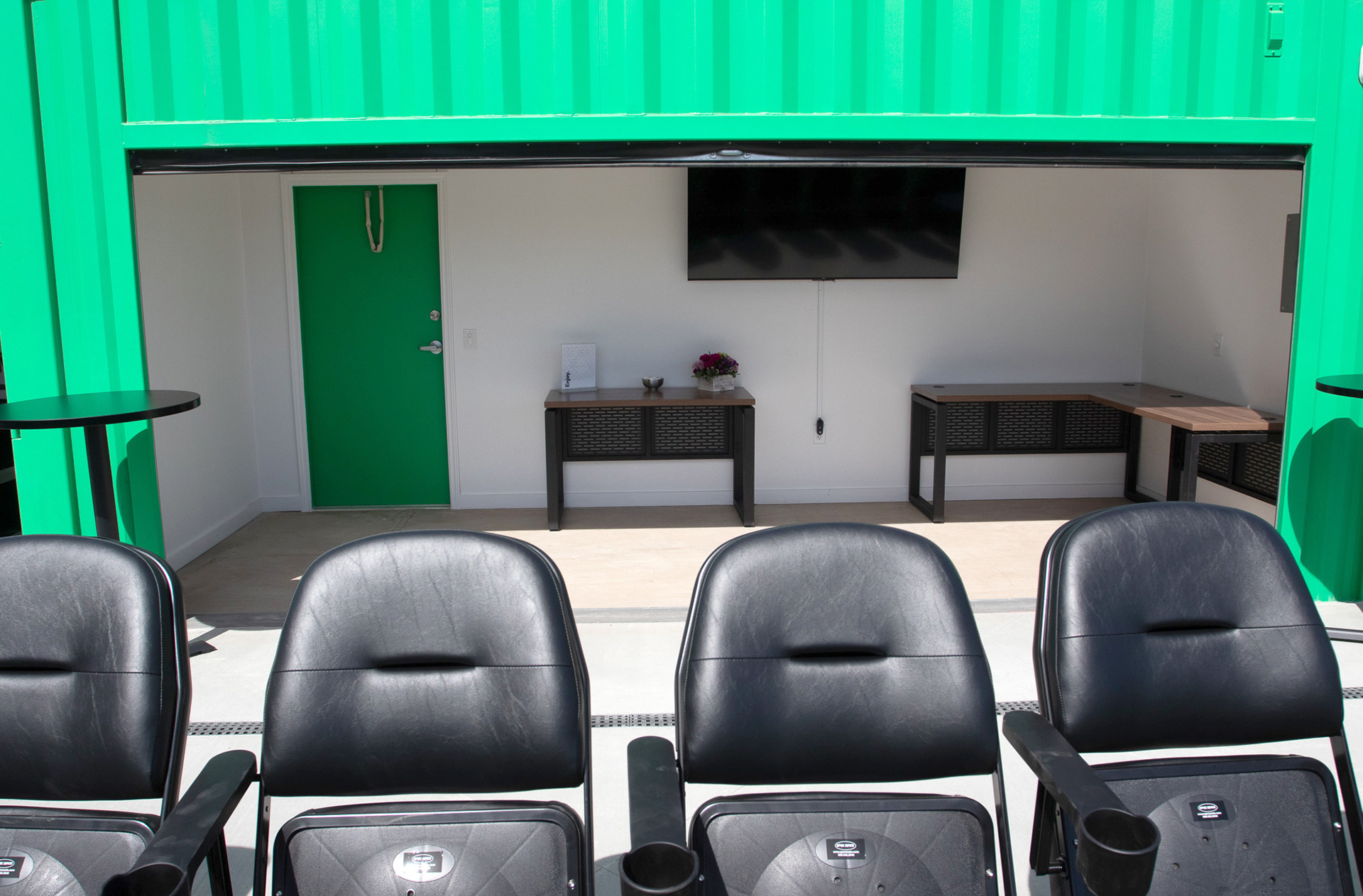 containers converted into sideline suites behind the pitch along goal line