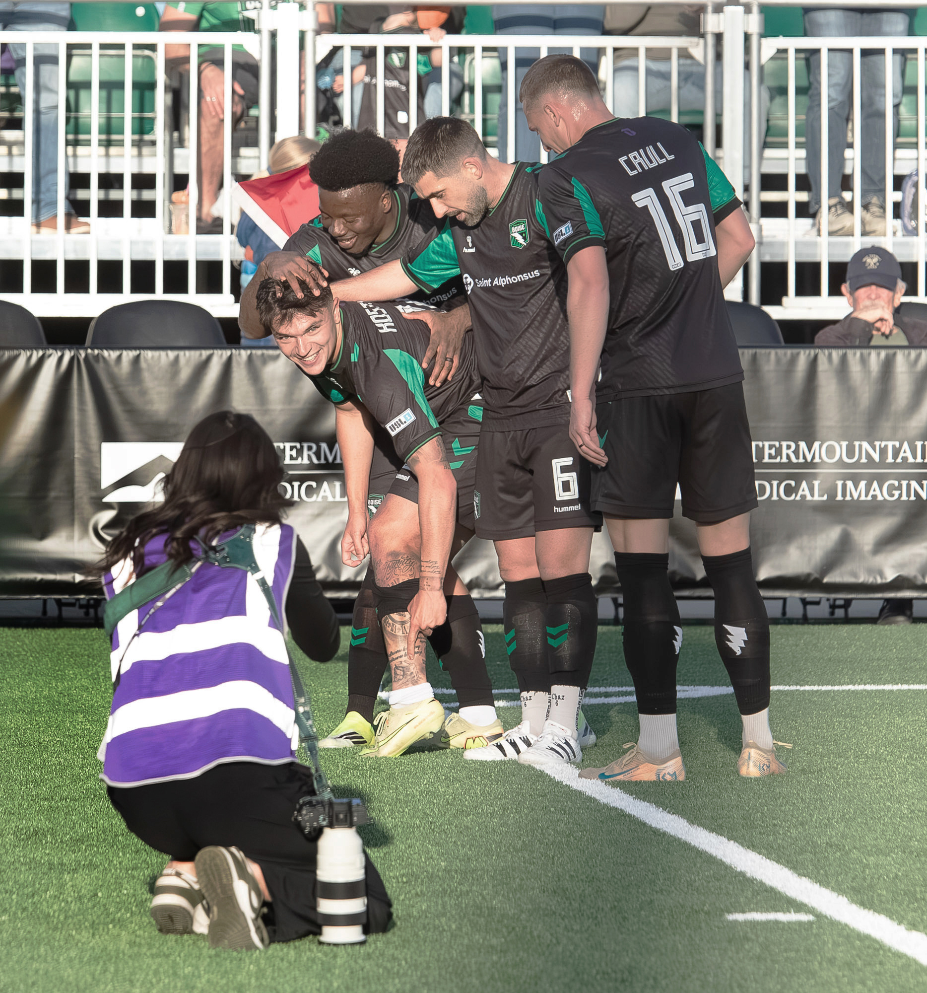 Denys Kostyshyn (10) of Athletic Club Boise points to a tattoo on his leg as he is greeted by teammates after scoring a goal in a soccer match against Westchester Soccer Club at Les Bois Park on Saturday.