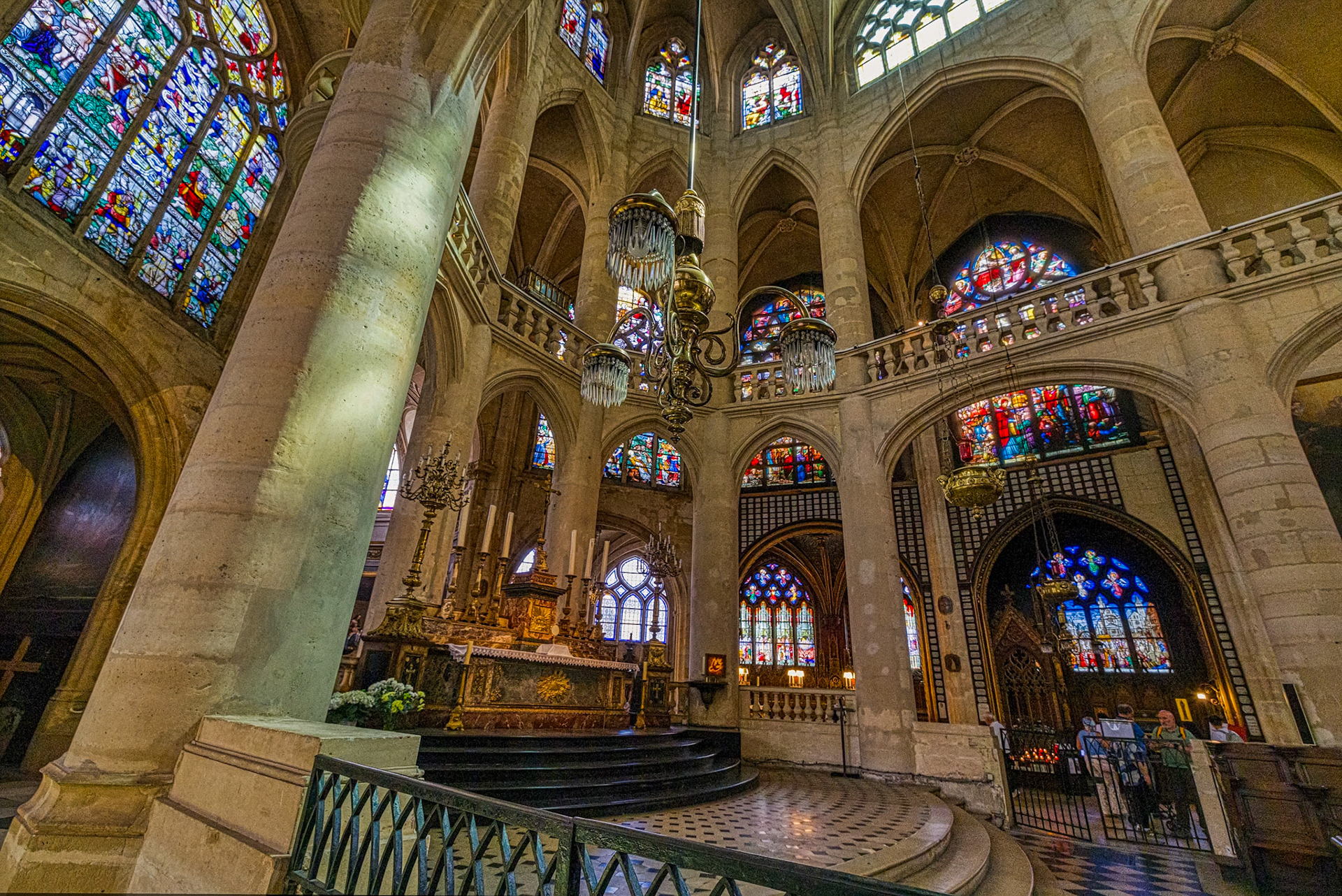 Dome and frescoes converge above a statue of the Virgin Mary in quiet reverence.