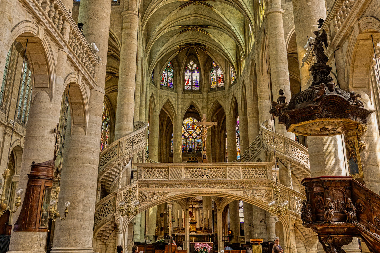 A sweeping view of the nave with the rare stone jjubé - a carved rood screen, unique in Pari