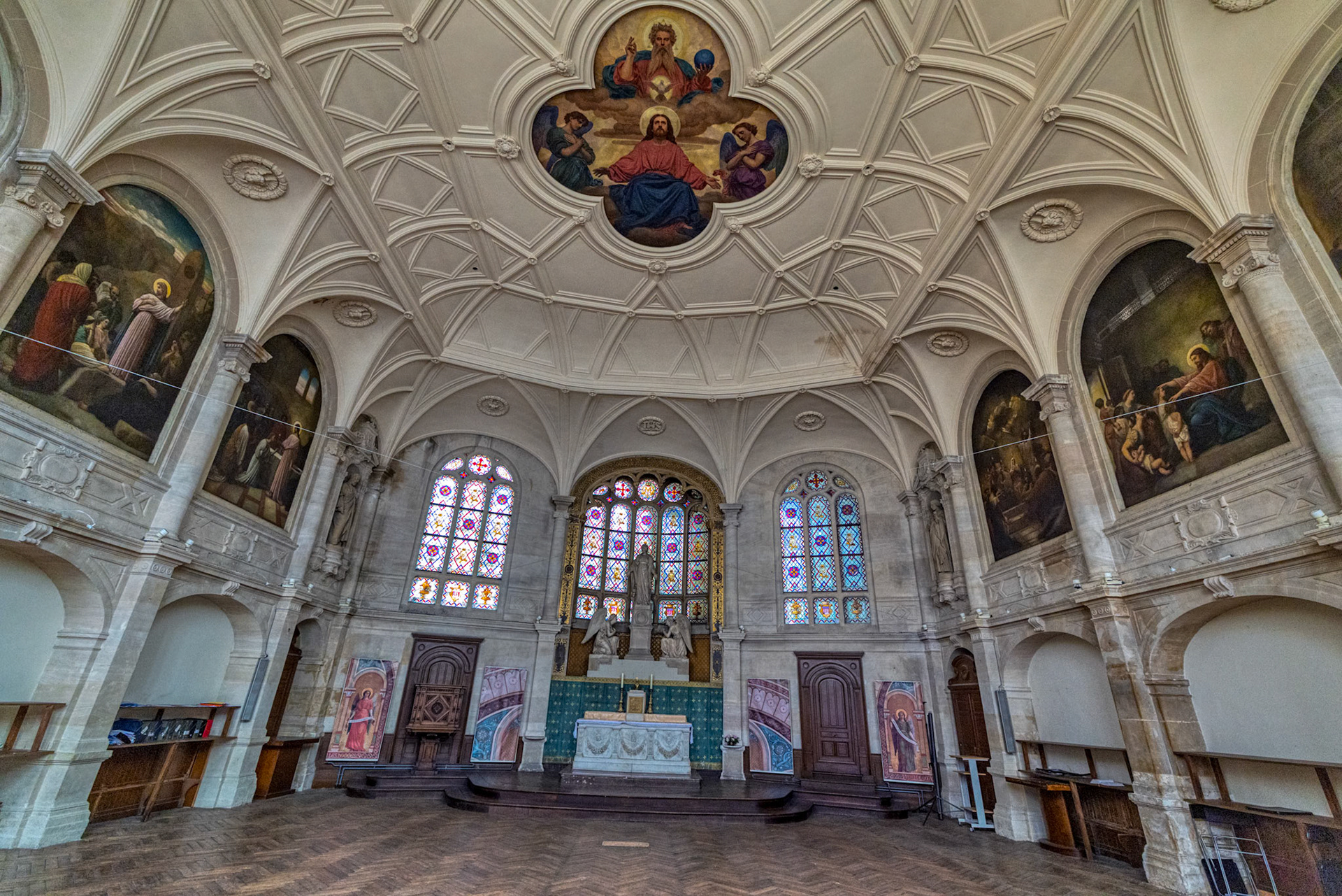 Vaulted chapel walls richly painted with biblical scenes and framed in soft natural light.