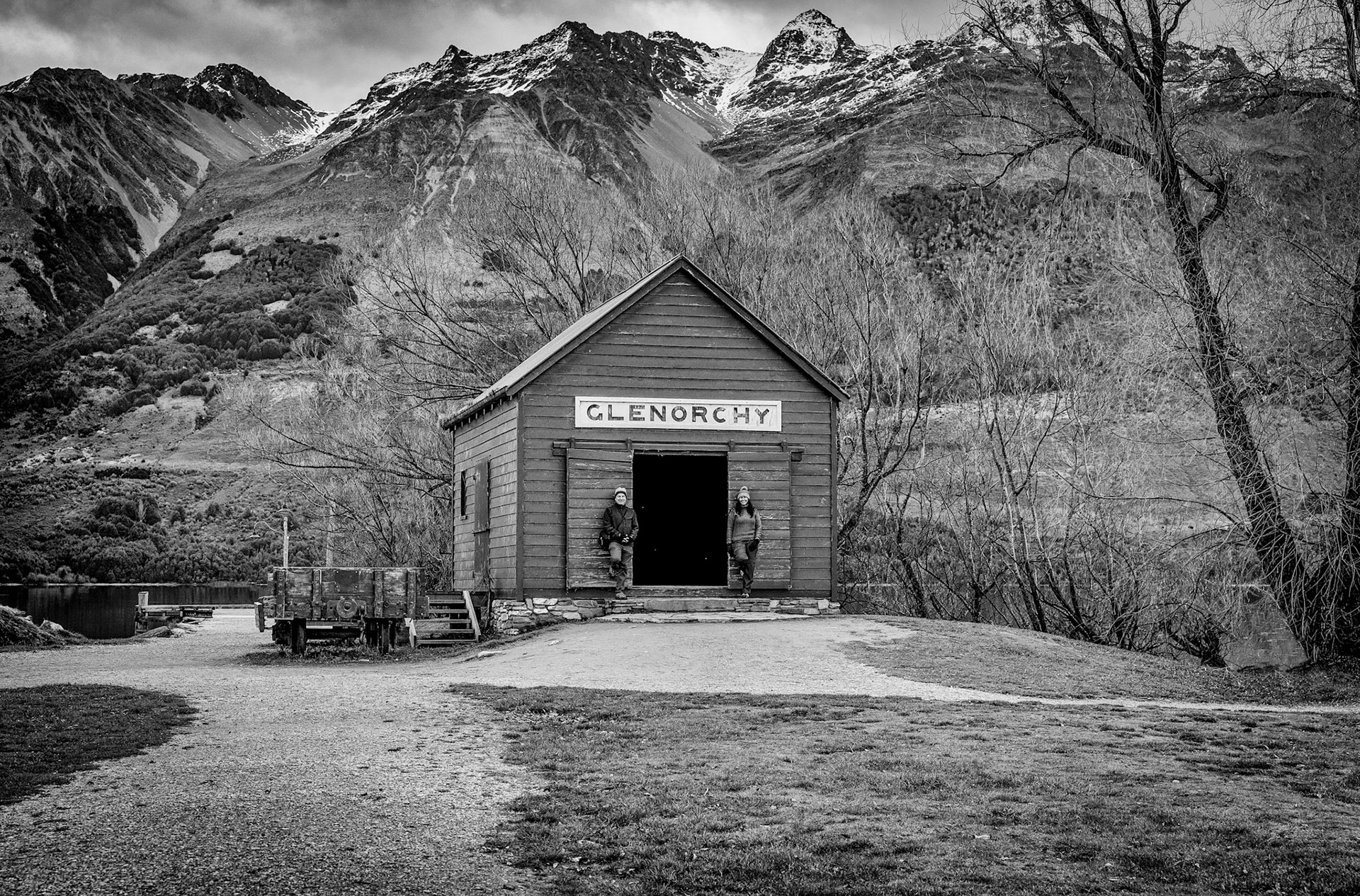 One of the most picture perfect places near Queenstown, New Zealand.  This particular self portrait of my wife and me done in black &amp; white, maybe helps deviate from the common pictures you may see of this iconic red barn found in Glenorchy.