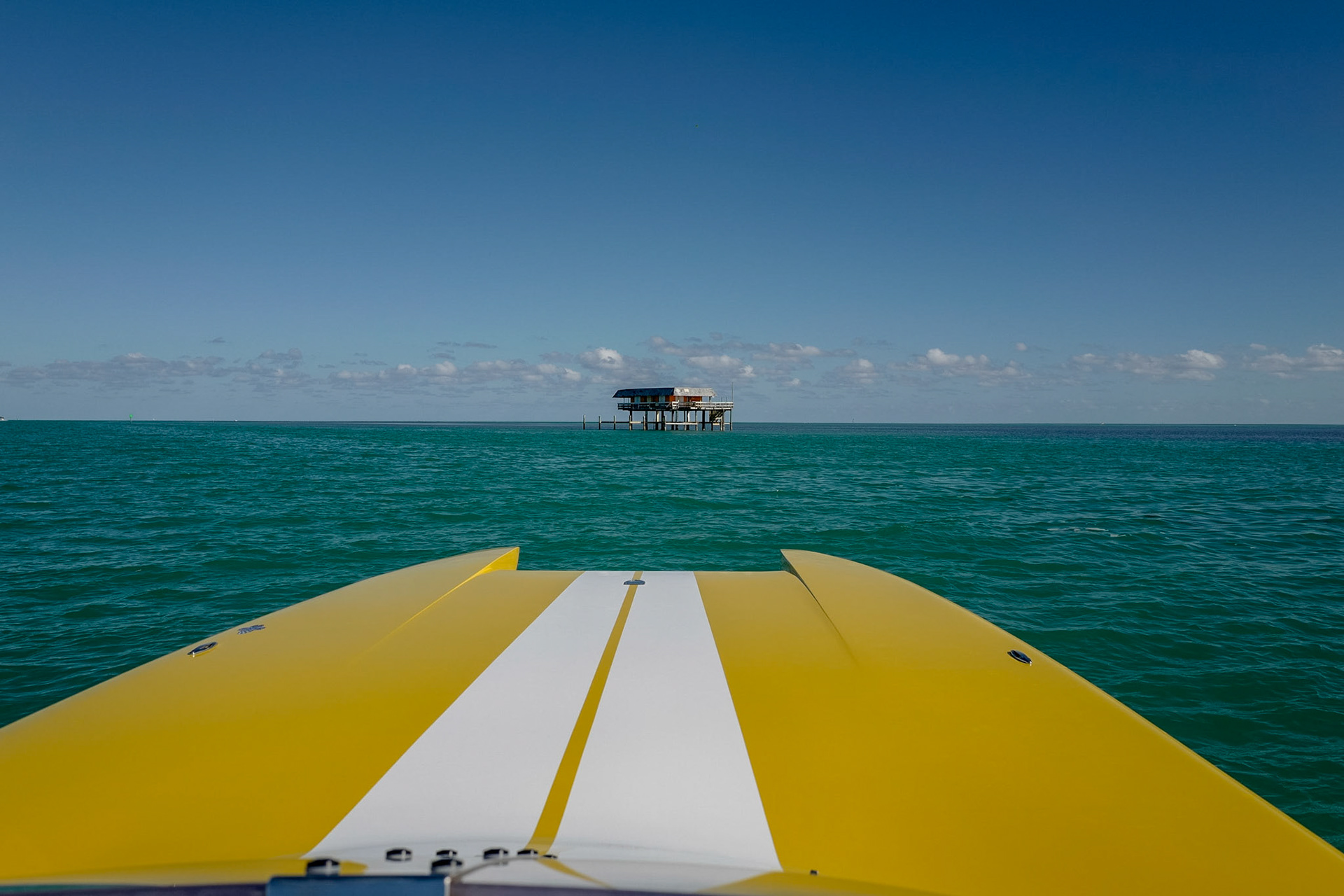 "Crawfish" Eddie Walker built a shack on stilts above the water in 1933, toward the end of the prohibition era, allegedly to facilitate gambling, which was legal at one mile offshore. Crawfish Eddie sold bait and beer from his shack and was known for a dish he called chilau, a crawfish chowder made with crawfish he caught under his shack.