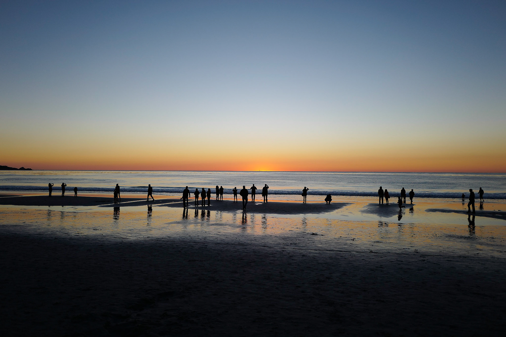 This picture taken in Carmel, California is one of my favourite silohettes.  Shows how people of all types enjoy gathering to watch the sun disappear below the Pacific Ocean.