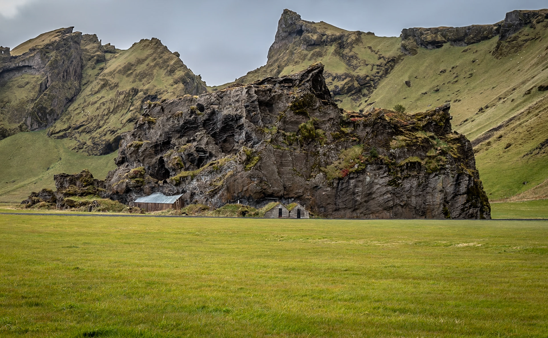 It's hard to tell what came first the massive rock formation in the field or the structures that appear to be overtaken by the rock.  Iceland is filled with magical scenes like this everywhere you look!