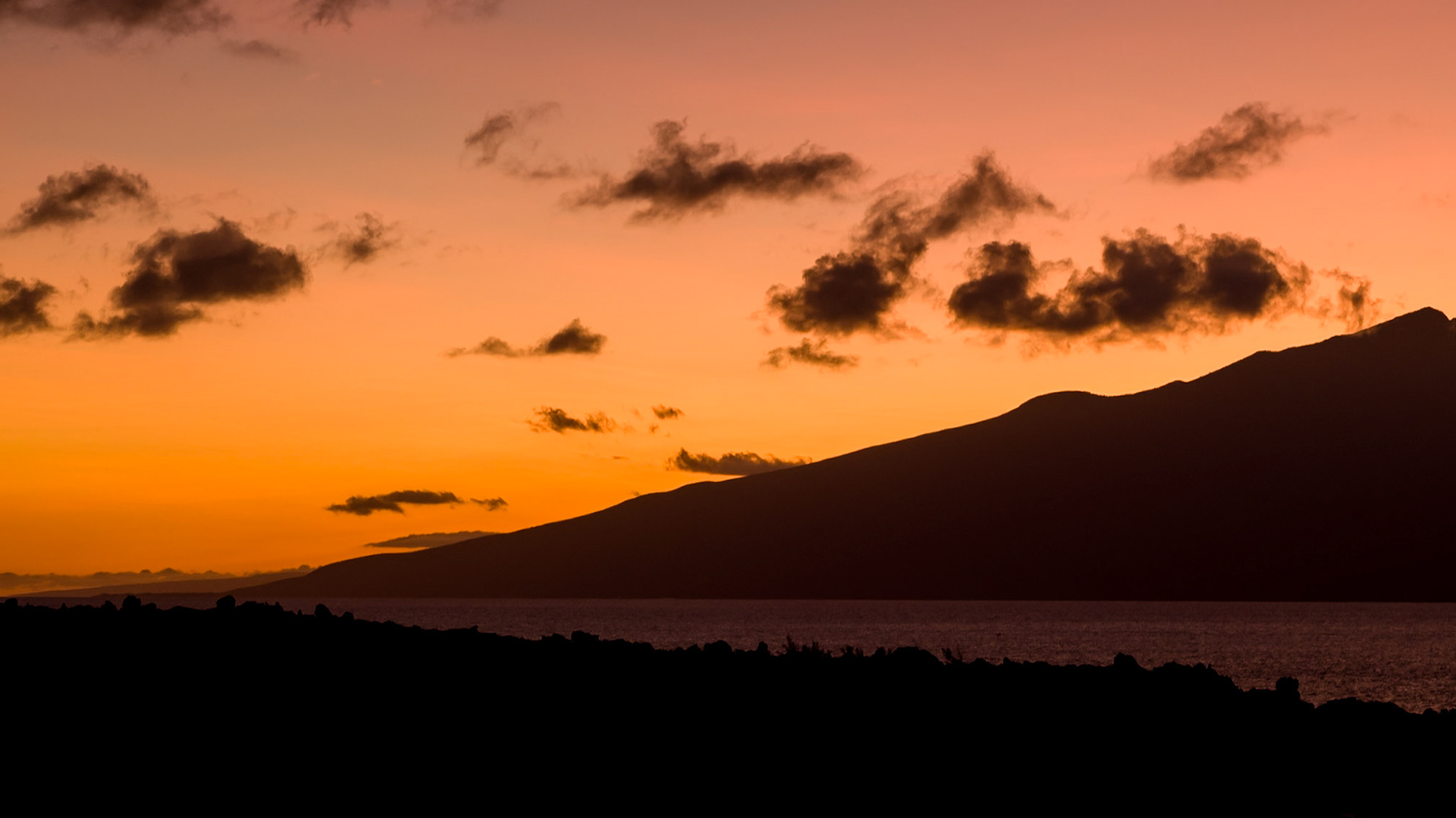 This photograph captures the silhouette Moloka'i emerging from the Pacific Ocean.  Another reason we love Kapalua Bay in Maui, Hawaii.