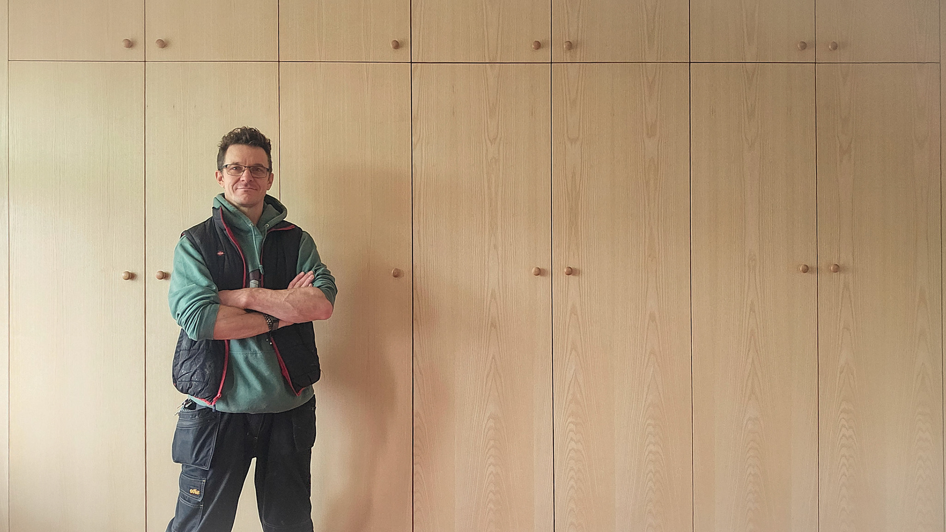 Wall to Wall fitted Wardrobes with grain matched ash doors.