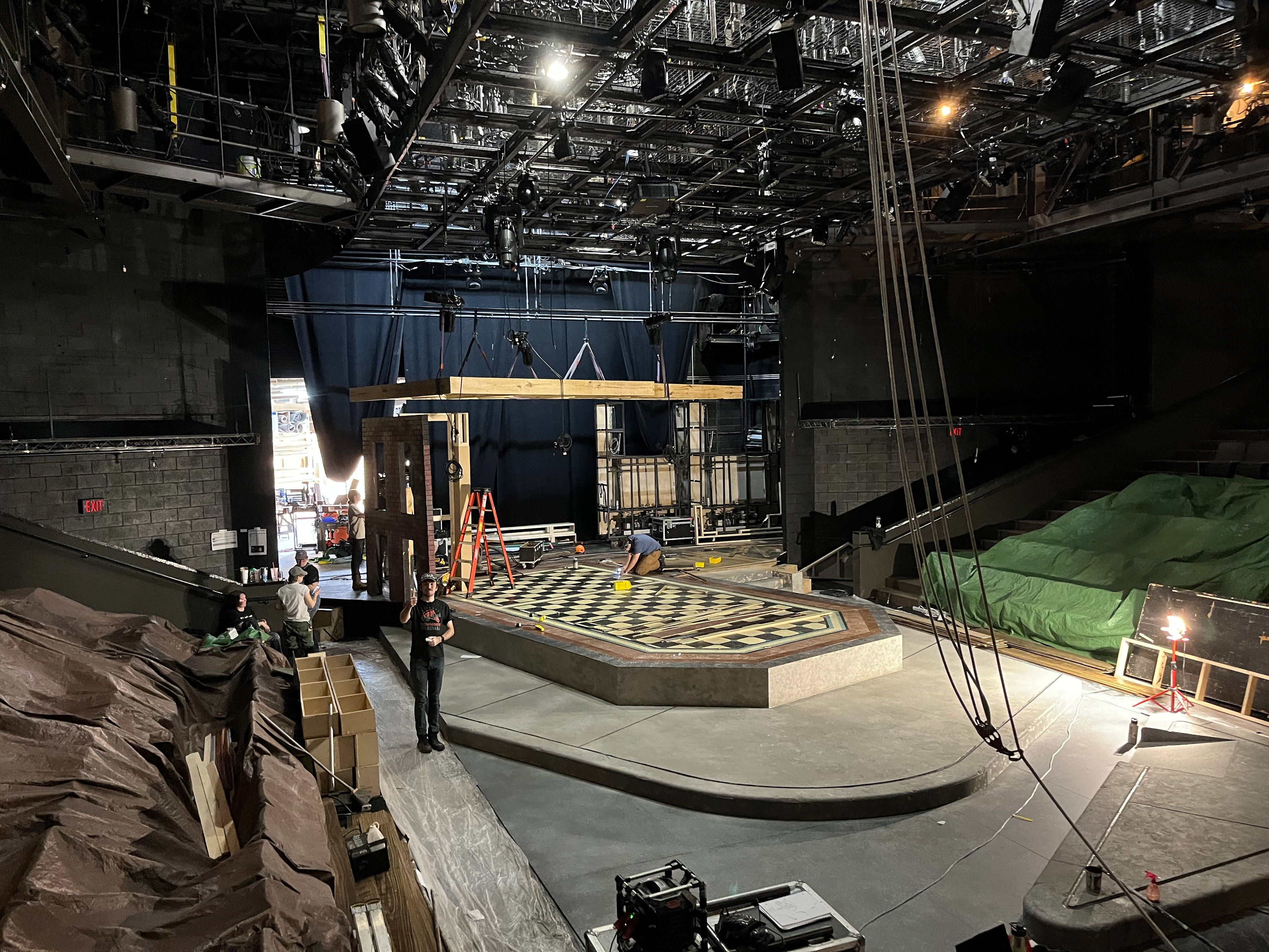 Load-in in progress - upper level held up on chain motors while supporting walls are installed underneath