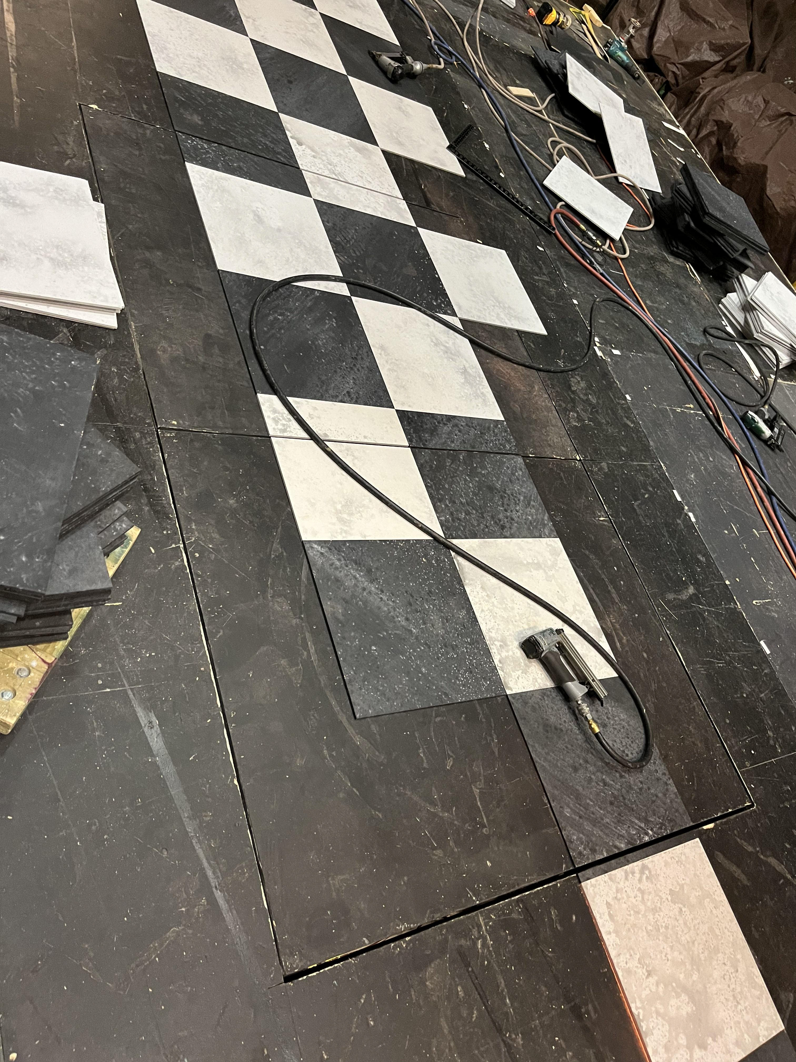 Floor tiles cut to fit in place for moon doors.