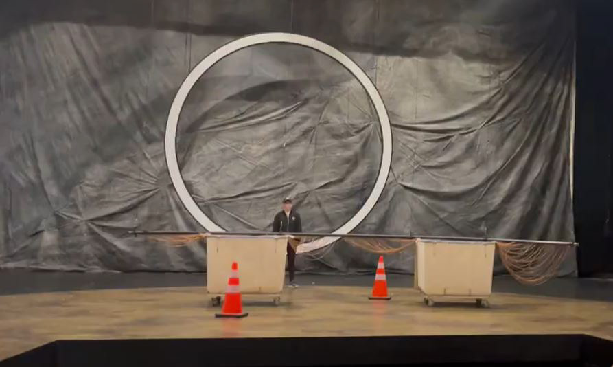 Rep storage for chain curtain: lower chain into two hampers, curved pipe rides on top of both.