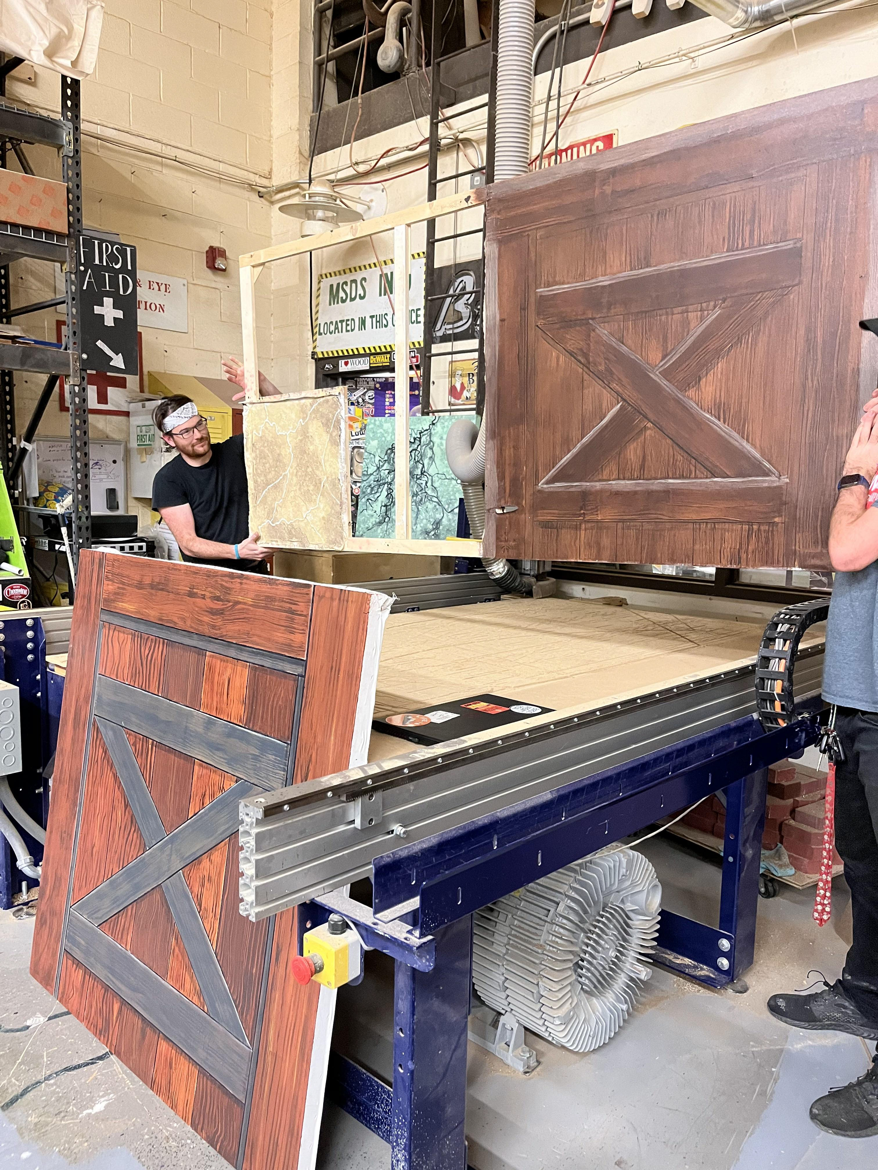 Joel very kindly holding up my project for presentations. The barn door on the floor is his!