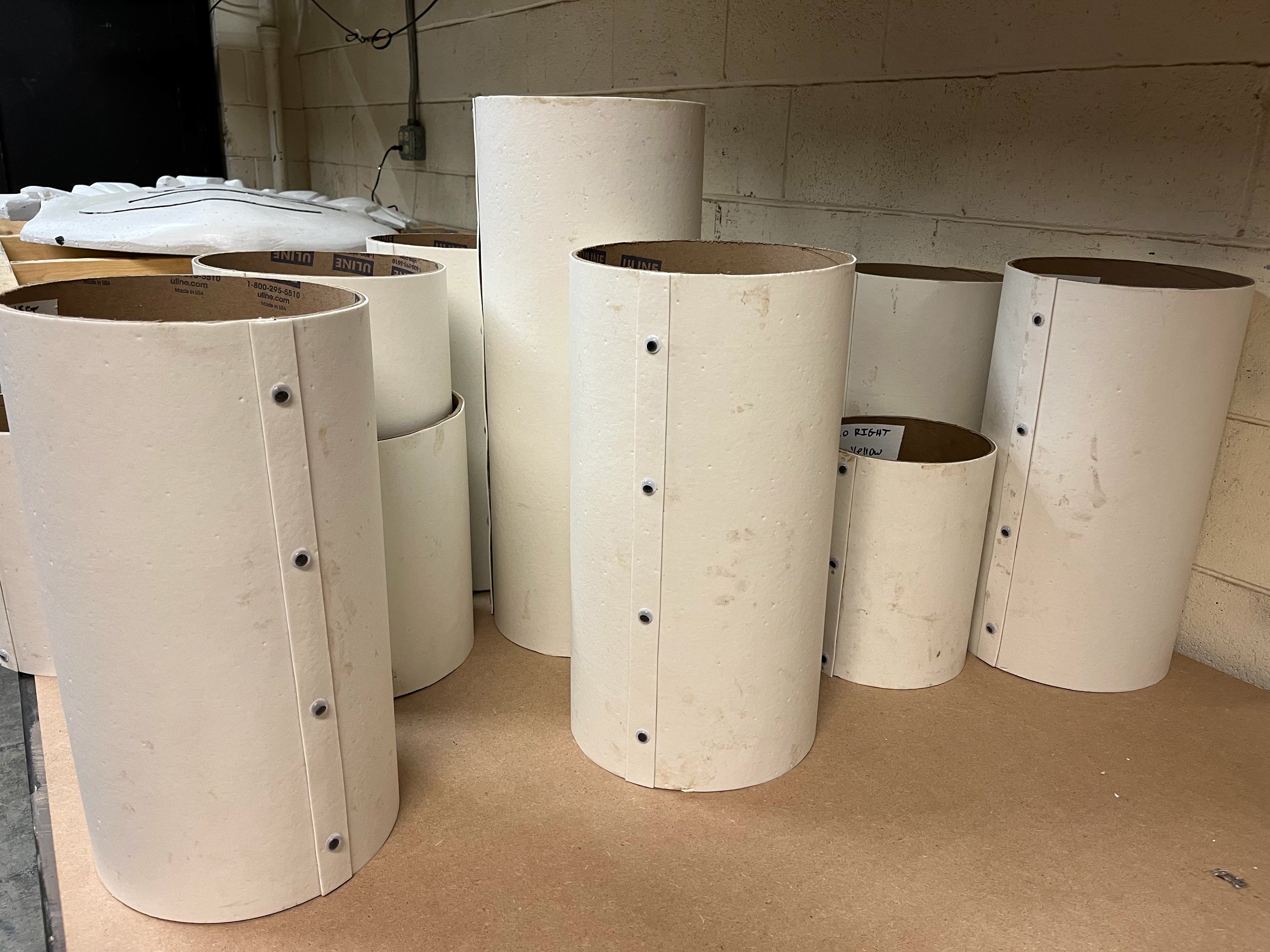 Sonotube was wrapped in vinyl to give paints a clean surface to bronze. Googly eyes were added as "rivets".