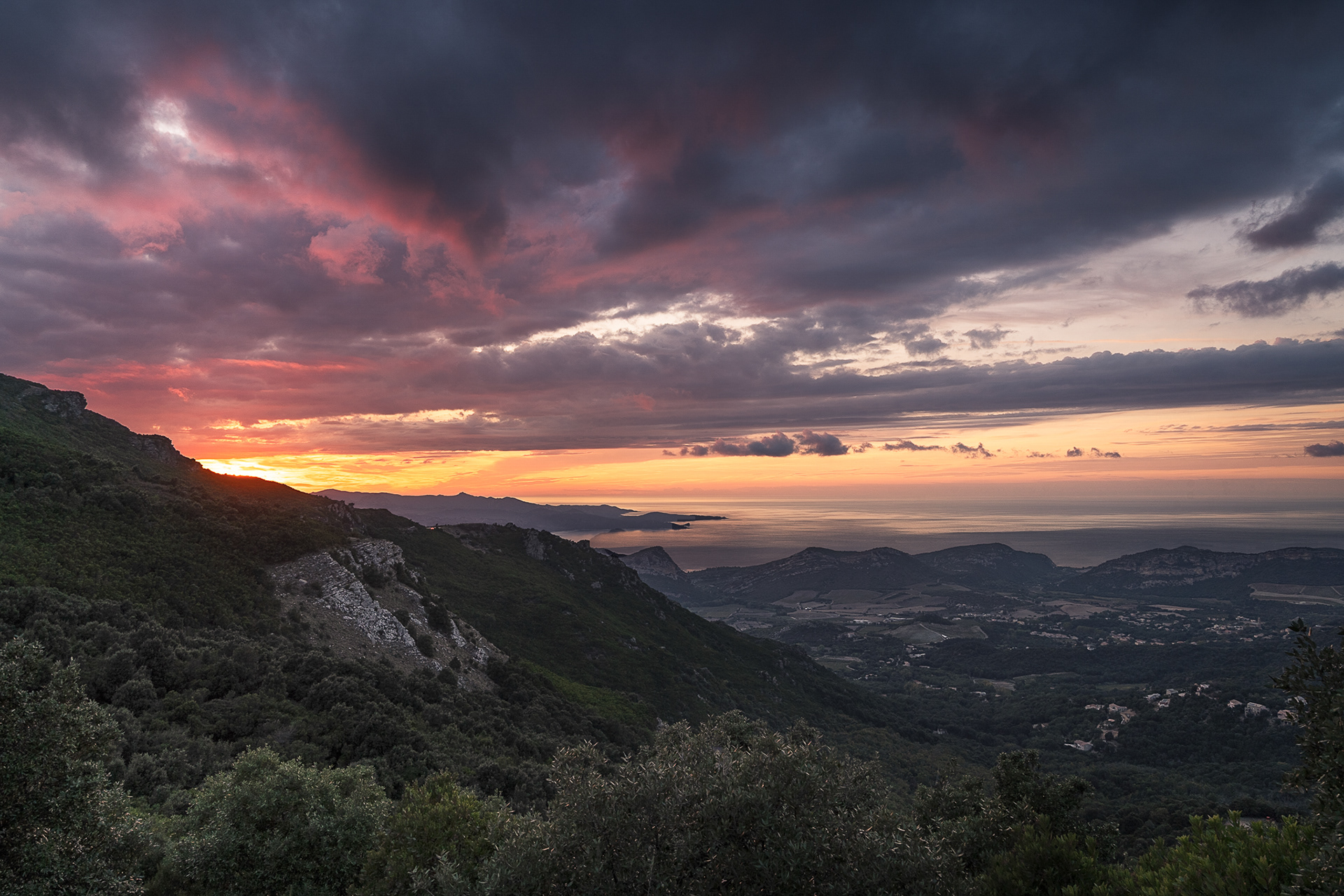 A dramatic sunset over the Corsican landscape