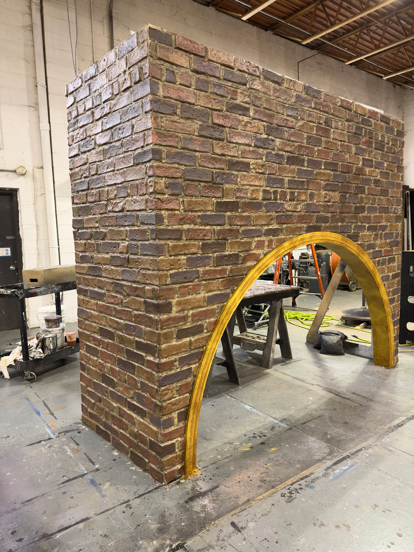 Scenery | Brick with Aged Gold trim | "Strategic Love Play", Directed by Katie Posner, Scenic Design by Arnulfo Maldonado, Audible Theater