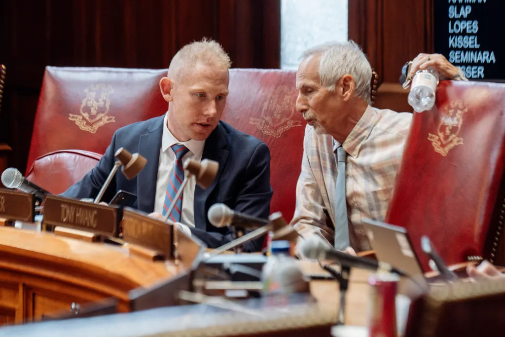 Stephen Harding, R-Brookfield, and Norm Needleman, D-Essex, conversing during senate session in Hartford on Wednesday, June 26, 2024.