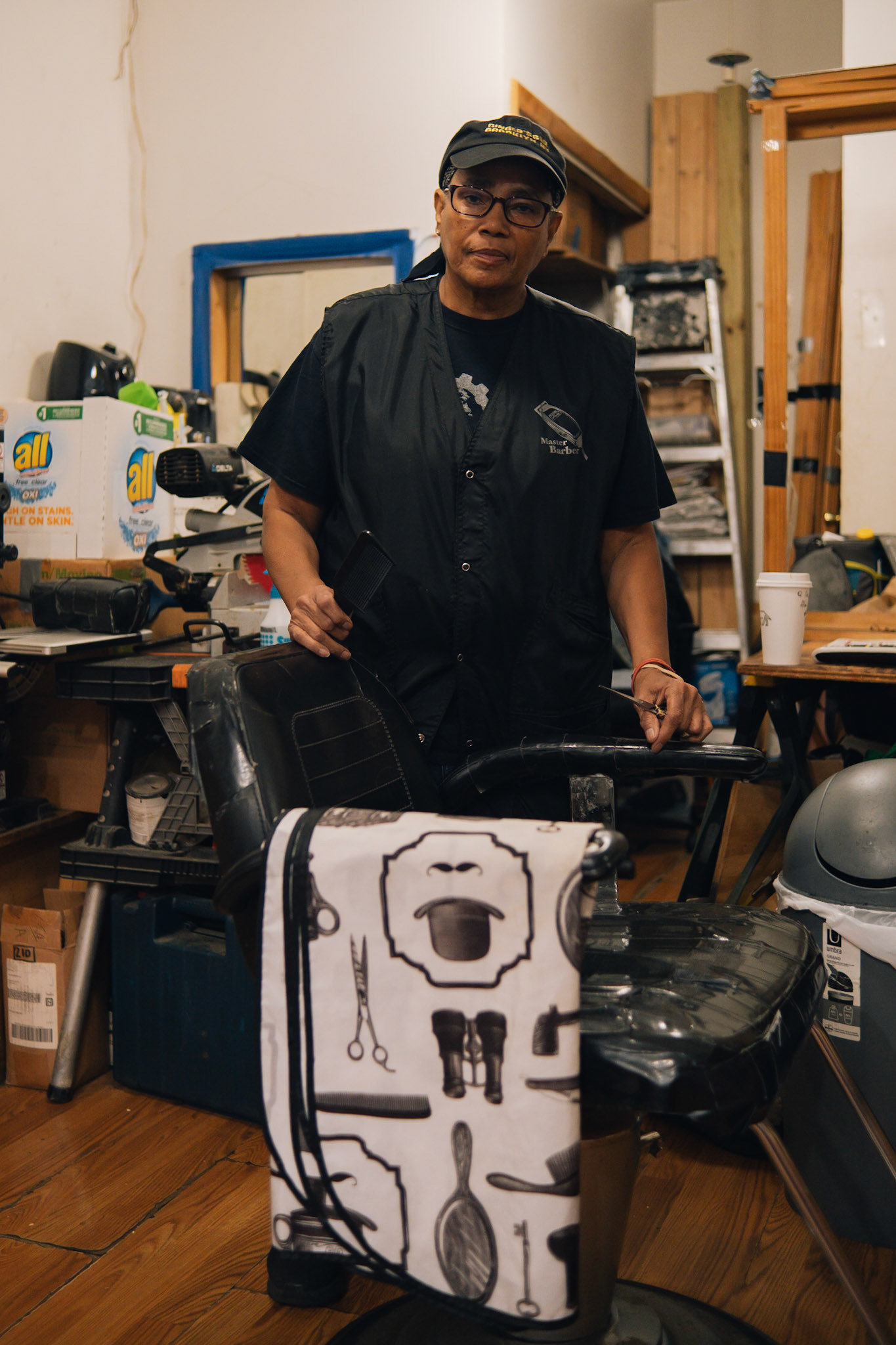 Ruth Borie, owner of Ruthie’s Neighborhood Barber Shop, stands near her barbering chair holding her cutting shears in her shop in Brooklyn, Saturday, Sep. 30, 2023, Photo Tabius McCoy