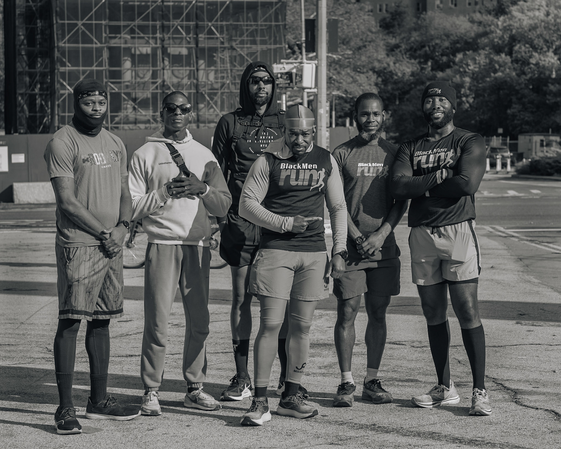 Members of Black Men Run NYC stand and pose for a picture after warming up for their weekly Sunday 3 mile run in Prospect Park in Brooklyn, Sunday, Oct. 15, 2023, Photo Tabius McCoy